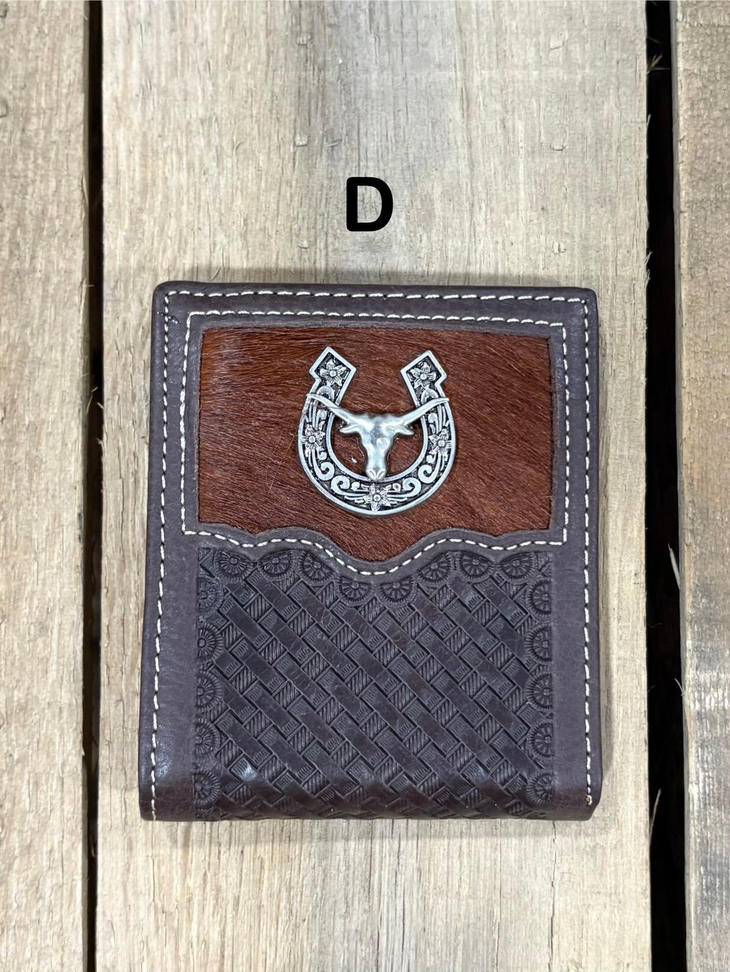 Coffee Brown leather wallet with embossed basketweave design and horseshoe and longhorn concho on a wooden surface
