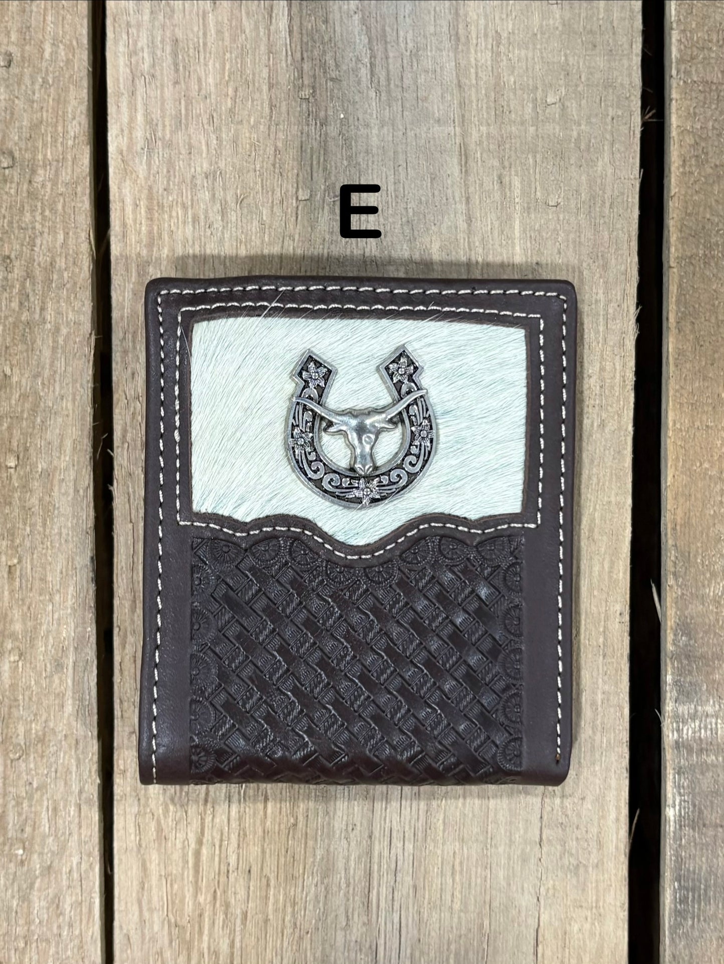 Coffee Brown leather wallet with embossed basketweave design and horseshoe and longhorn concho on a wooden surface