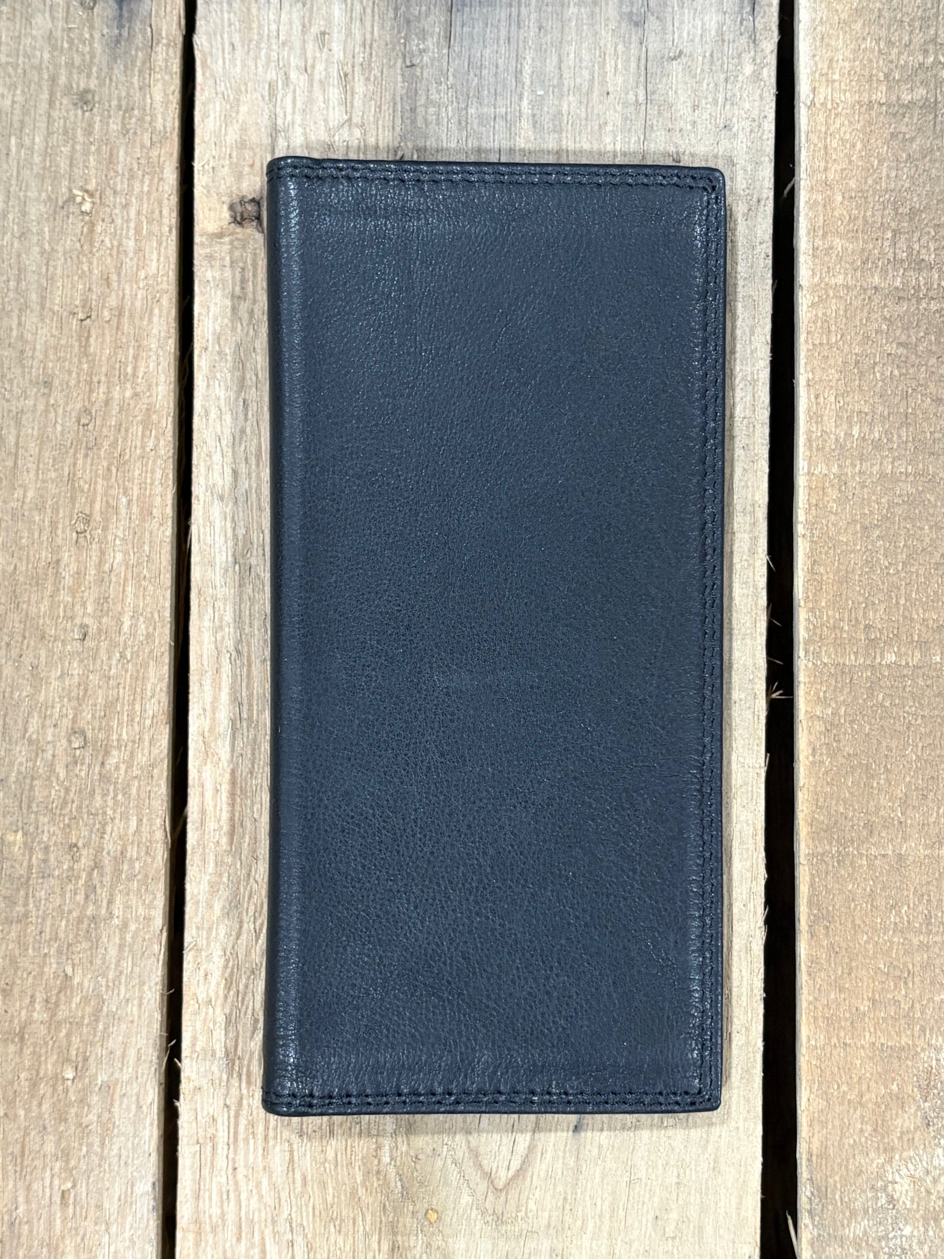 Black leather wallet on a wooden surface