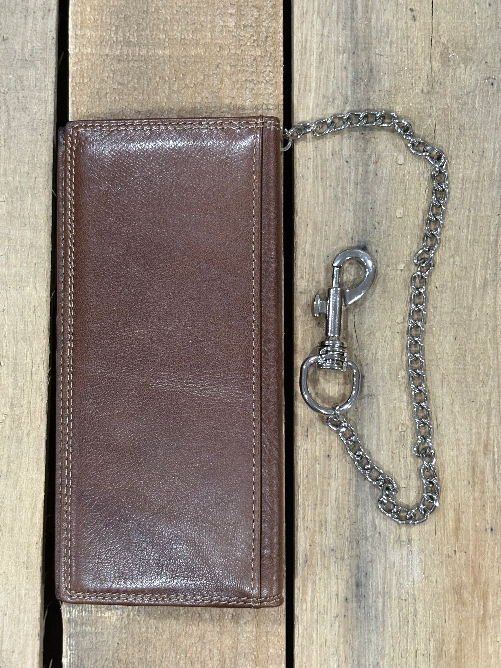 Brown leather wallet with a chain on a wooden surface