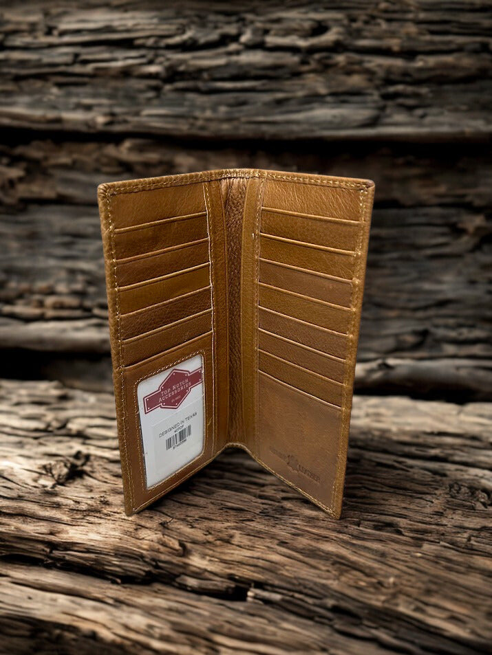 Brown leather wallet with a brand label on a wooden surface