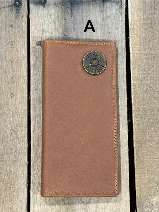 Brown leather wallet with a shotgun shell concho on a wooden surface