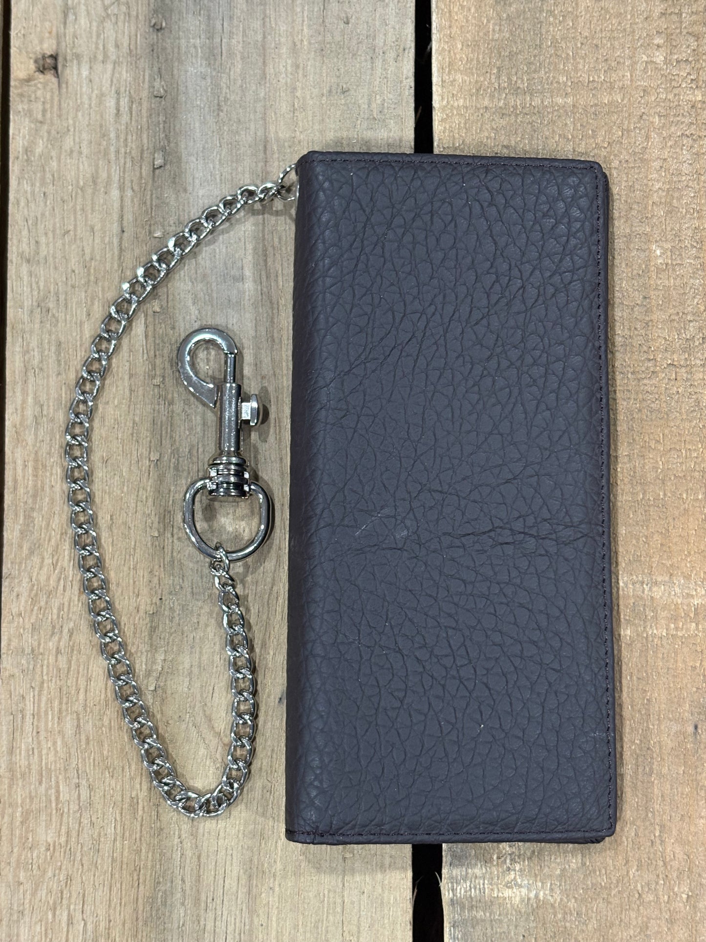 Black leather wallet with chain on a wooden surface