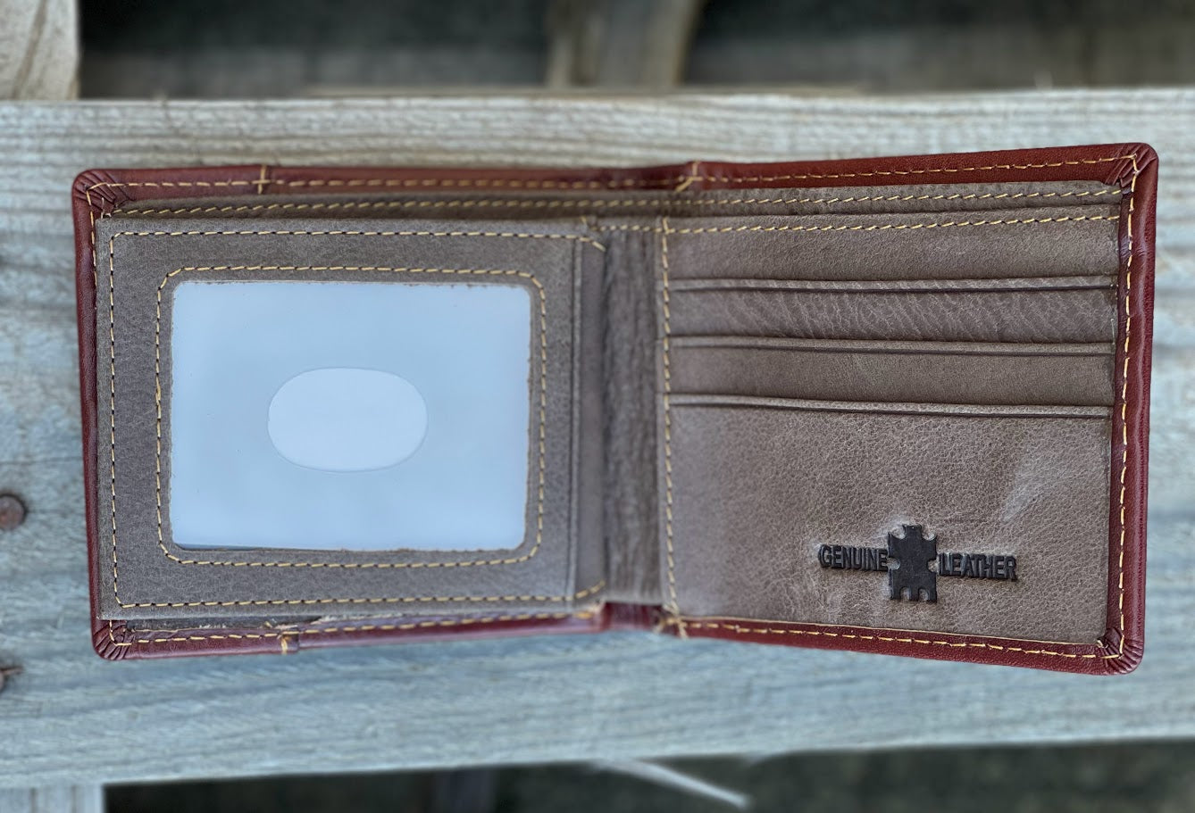 Brown leather bifold wallet. Inside view showing multiple card slots and a dual ID window. 