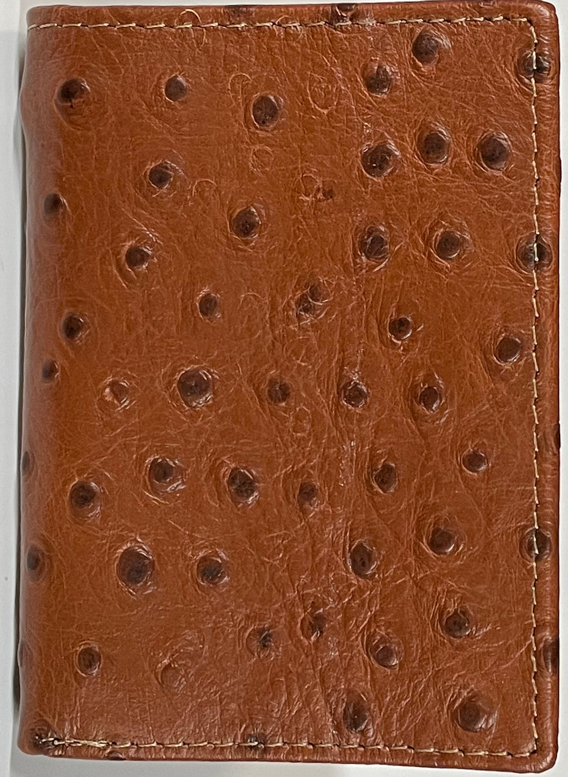 Close up view of a Brown leather wallet with a textured pattern on a white background