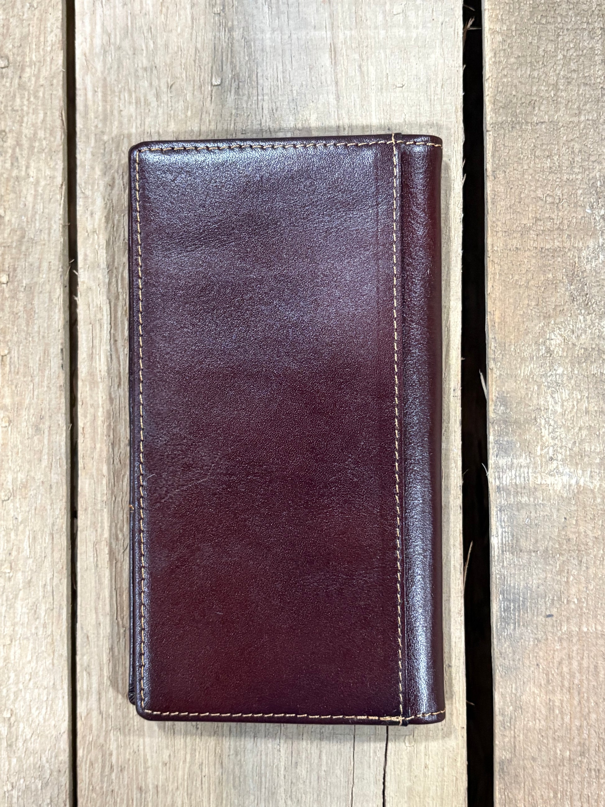 Coffee Brown leather wallet on a wooden surface