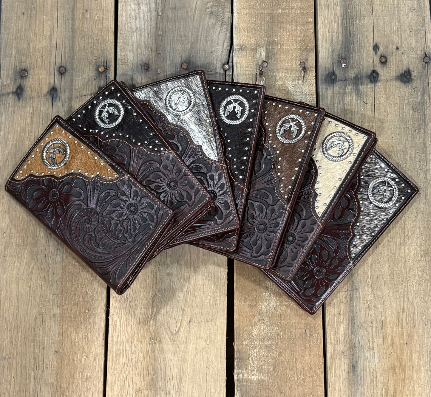 Profile of all the options of these Coffee Brown leather wallet with floral embossing and silver studs on a white background