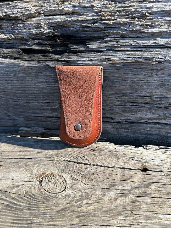 Brown leather knife sheath with a embossed Bull Rider design. Rear View