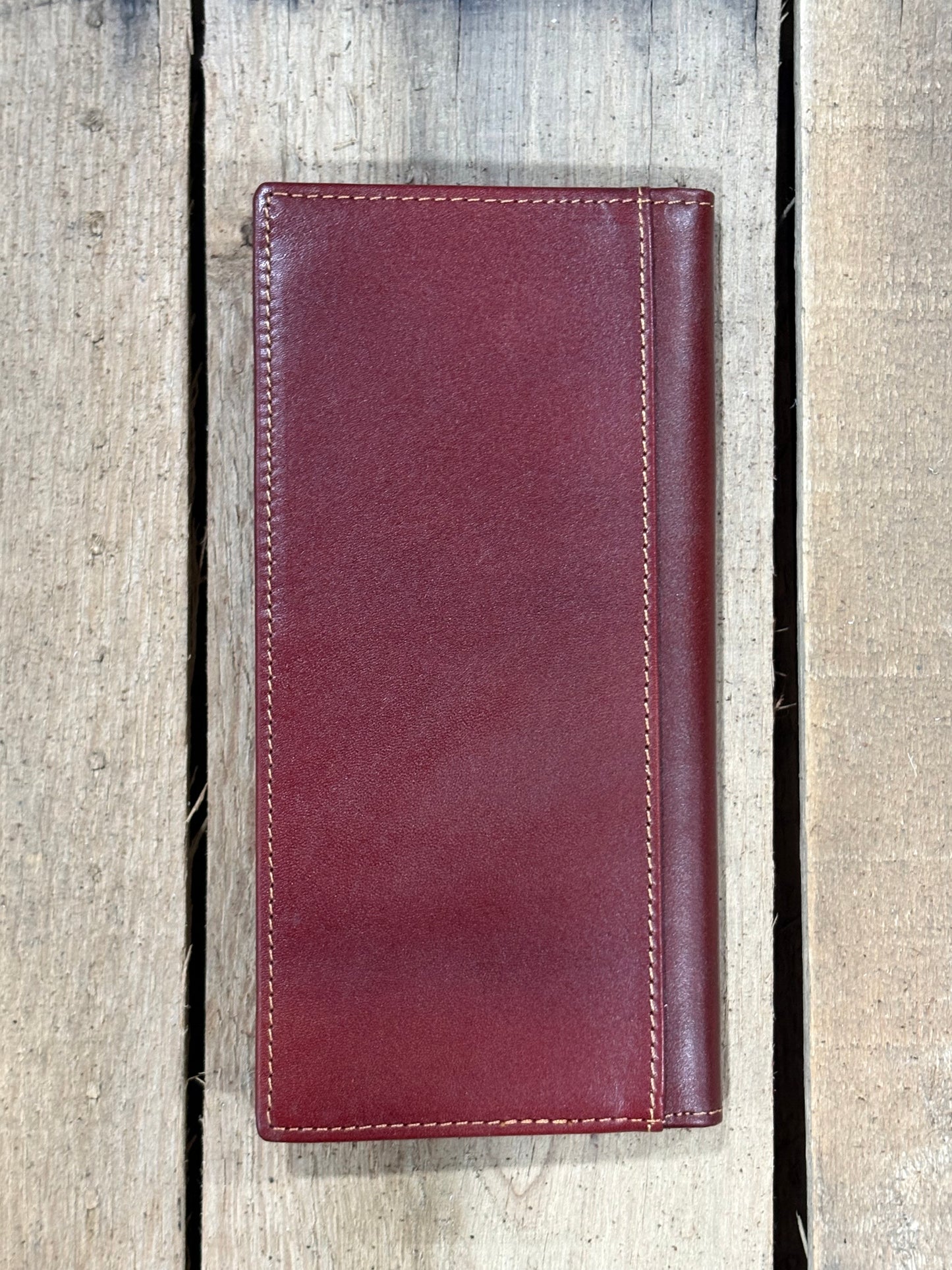 Brown leather wallet on a wooden background