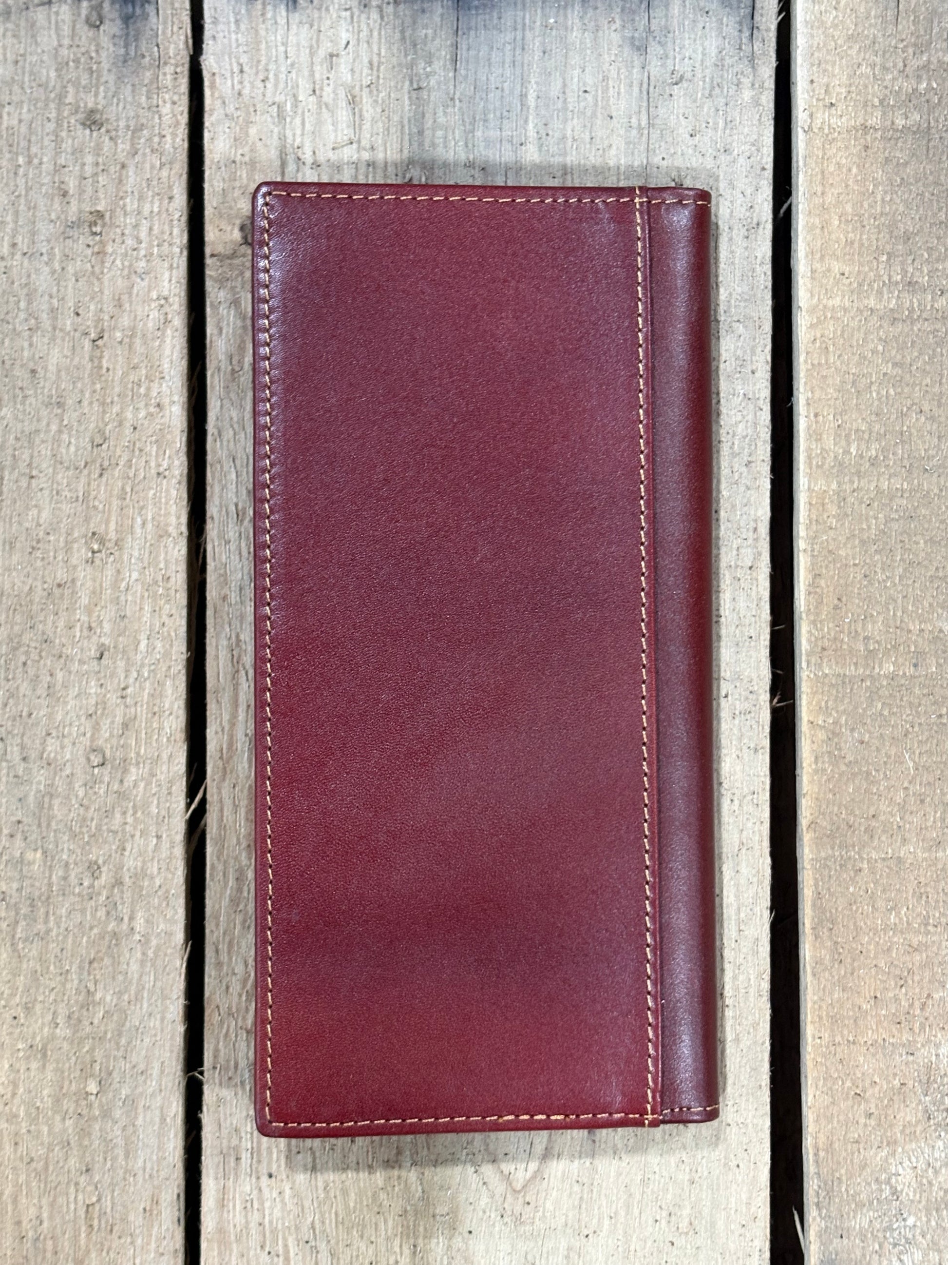 Brown leather wallet on a wooden background