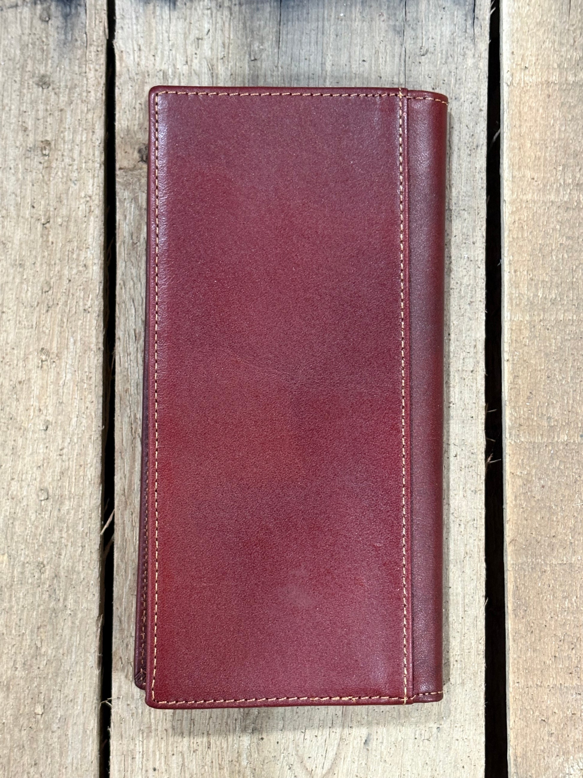 Brown leather wallet on a wooden surface