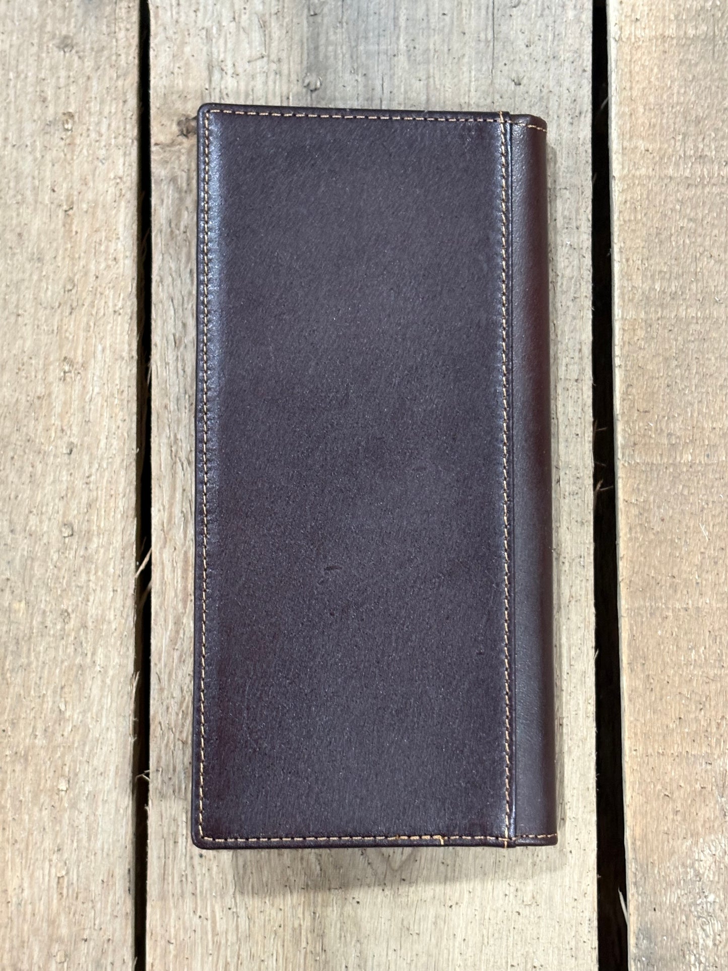 Coffee Brown leather wallet on a wooden surface