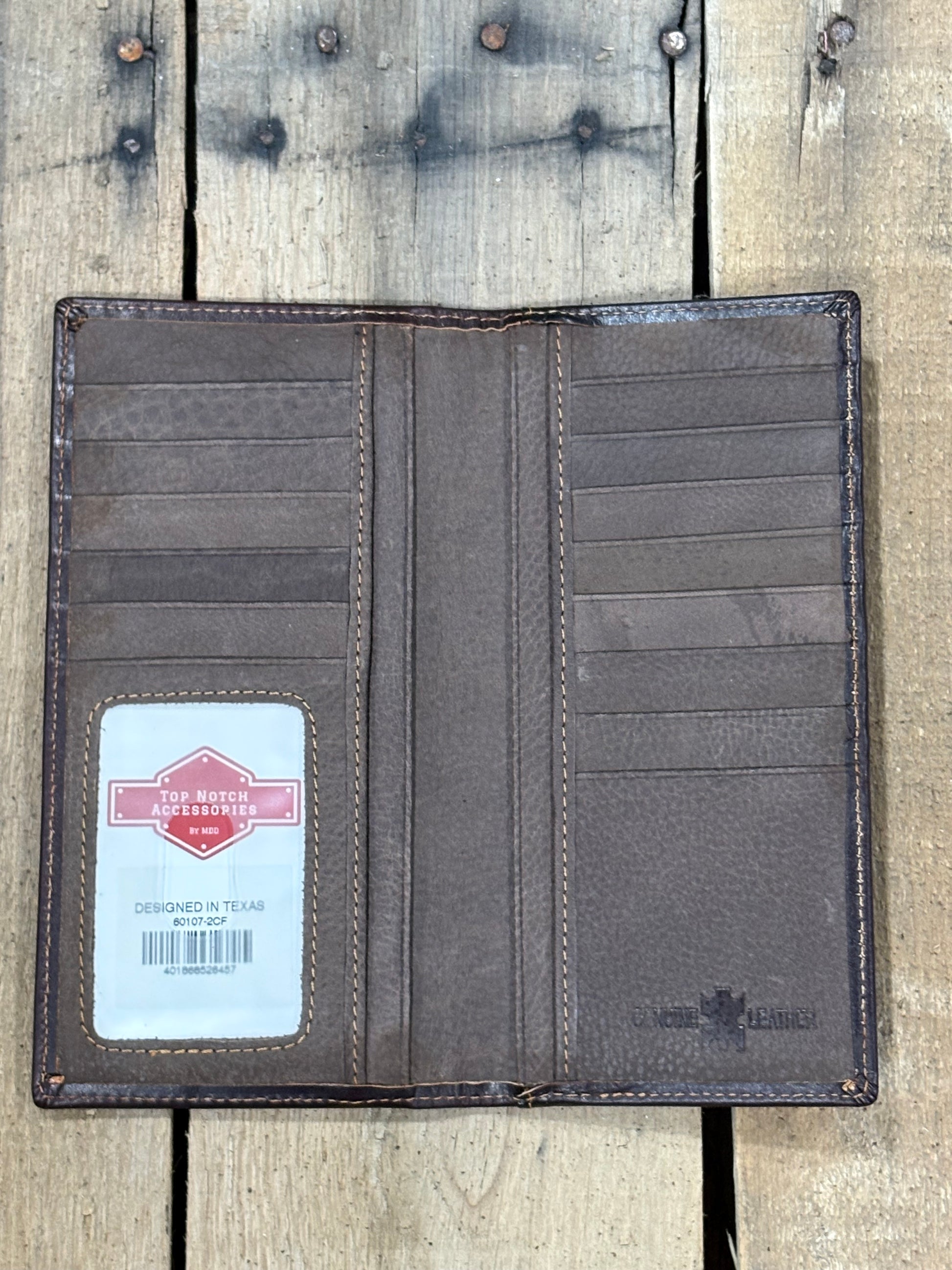 Inside View of Coffee Brown leather wallet with a brand label on a wooden surface