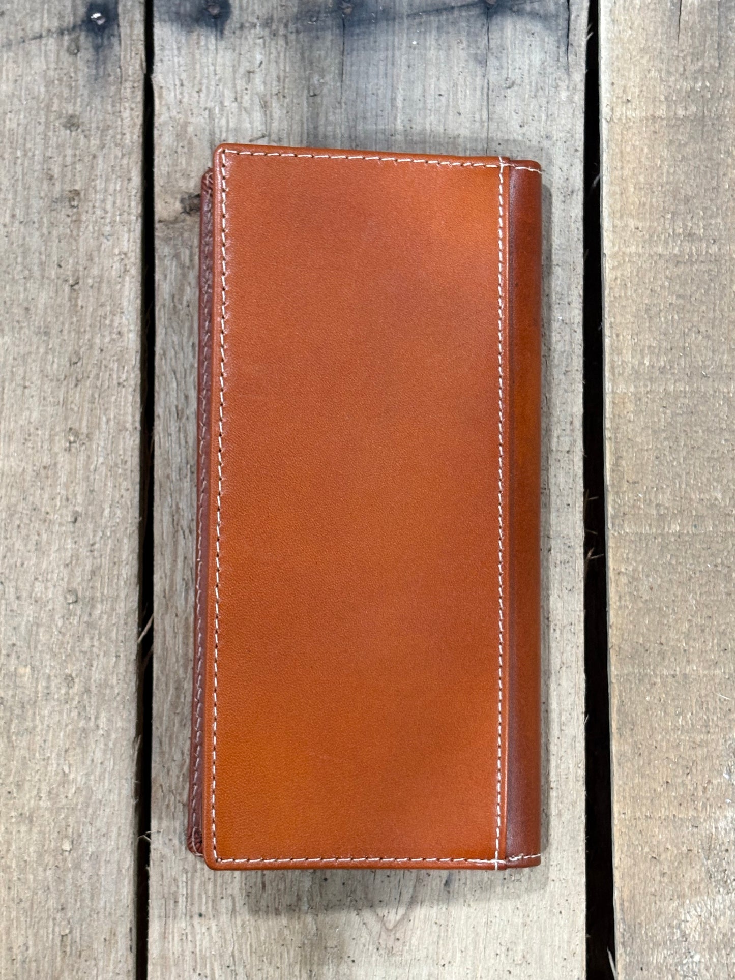 Light Brown leather wallet on a wooden background
