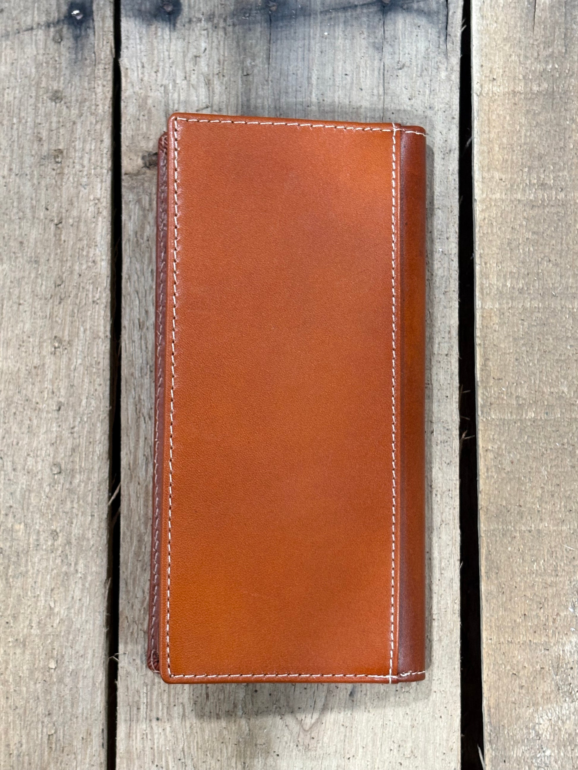 Light Brown leather wallet on a wooden background