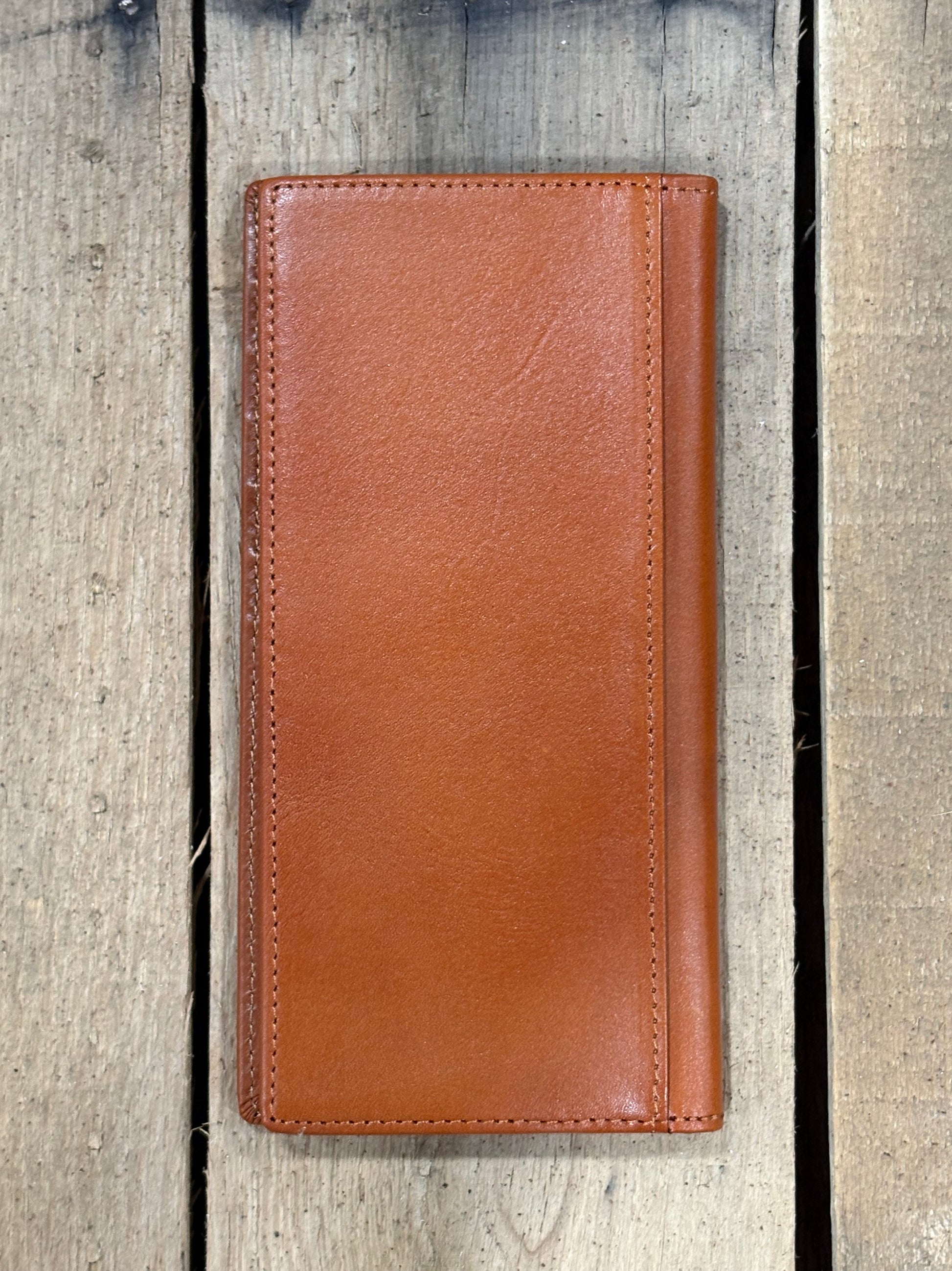 Light Brown leather wallet on a wooden surface