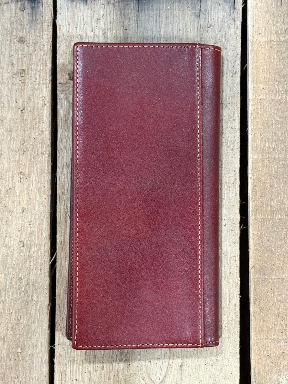 Brown leather wallet on a wooden surface