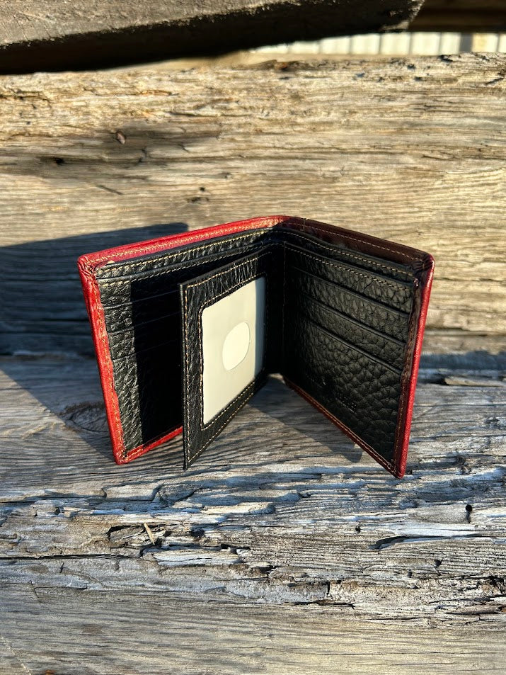 Black leather wallet with brown accents on a wooden surface