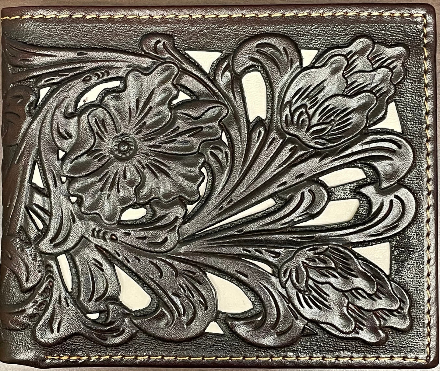 Close up of a Coffee Brown leather bifold wallet features a intricate tooled leather pattern with a Beige inlay. Front View