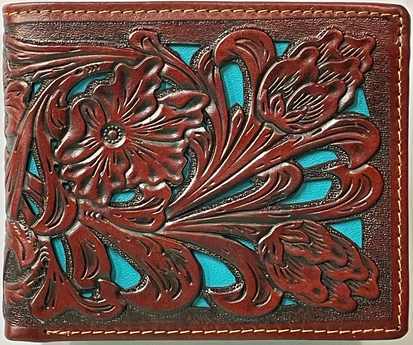 Close up of a Brown leather wallet with floral embossing and turquoise inlay