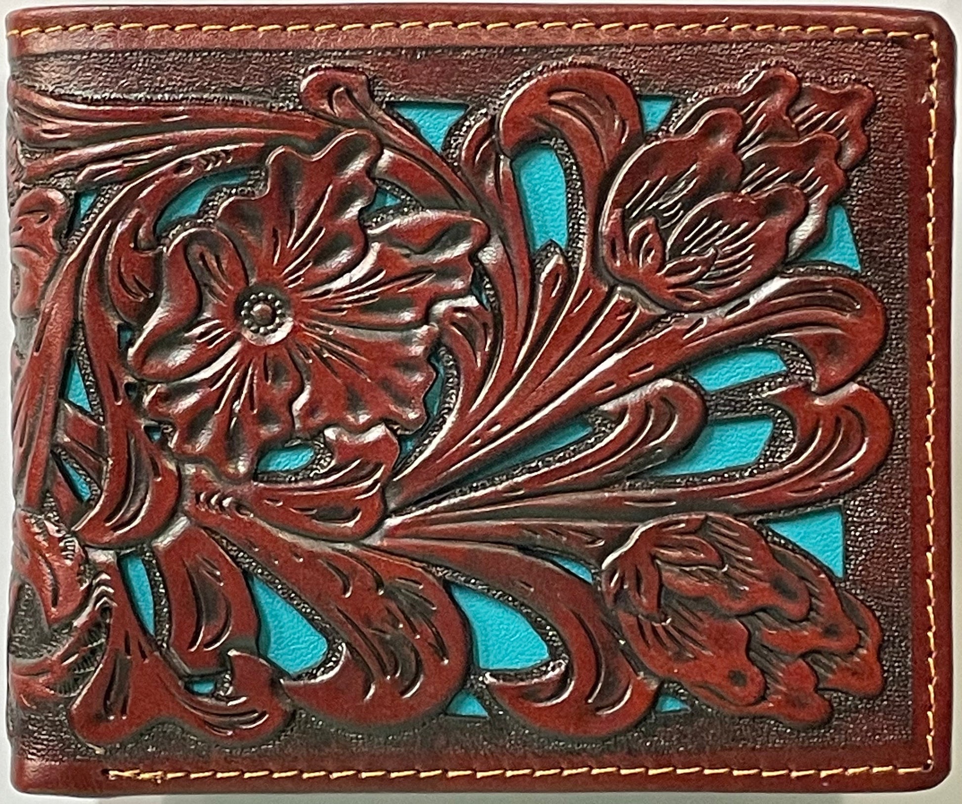 Close up of a Brown leather wallet with floral embossing and turquoise inlay