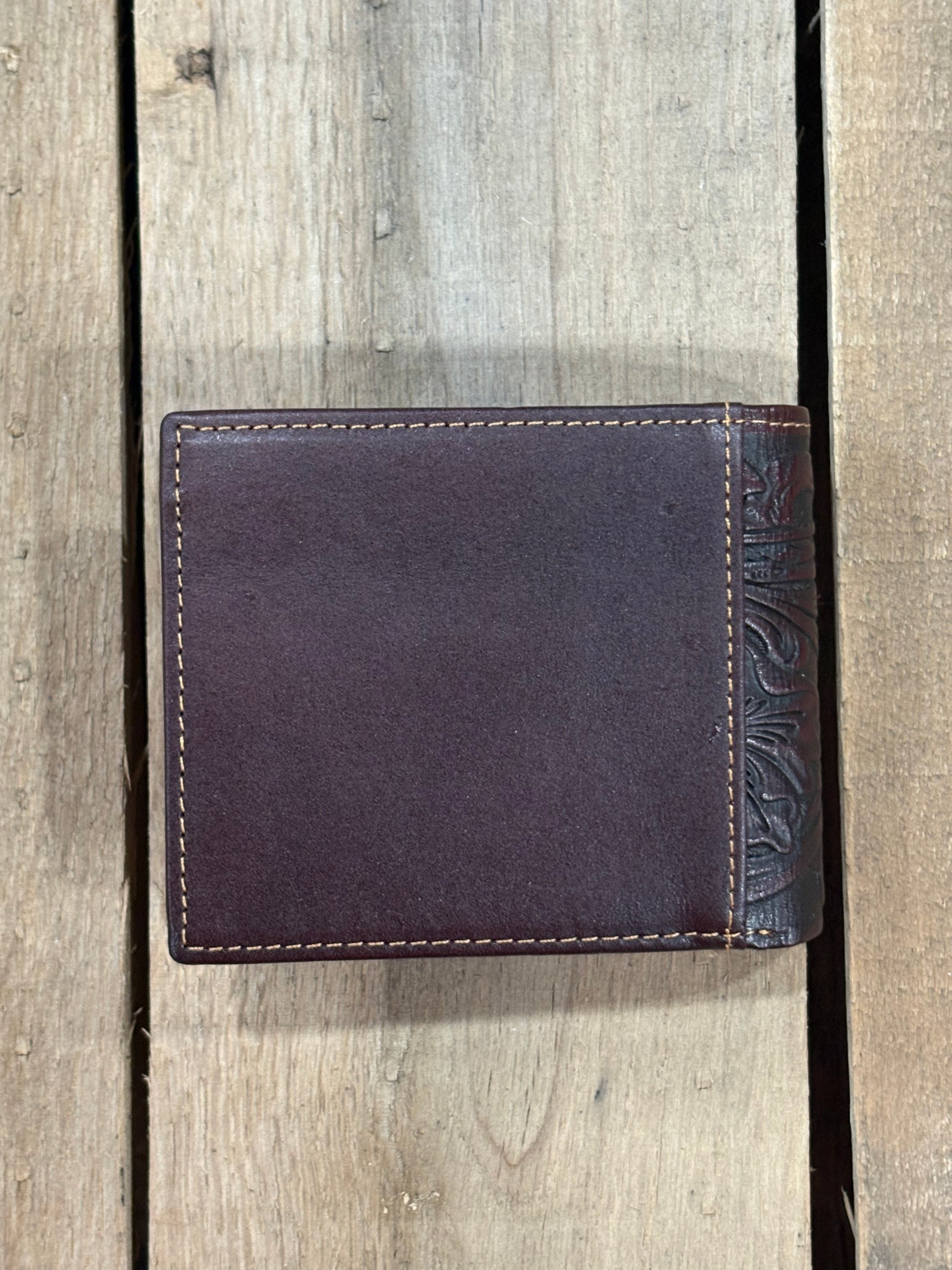 Brown smooth leather wallet on a wooden surface