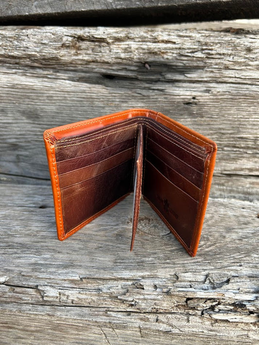 This Light Brown leather bifold wallet features a intricate tooled pattern over a  Beige inlay. Inside view showing multiple card slots and a dual ID window. 