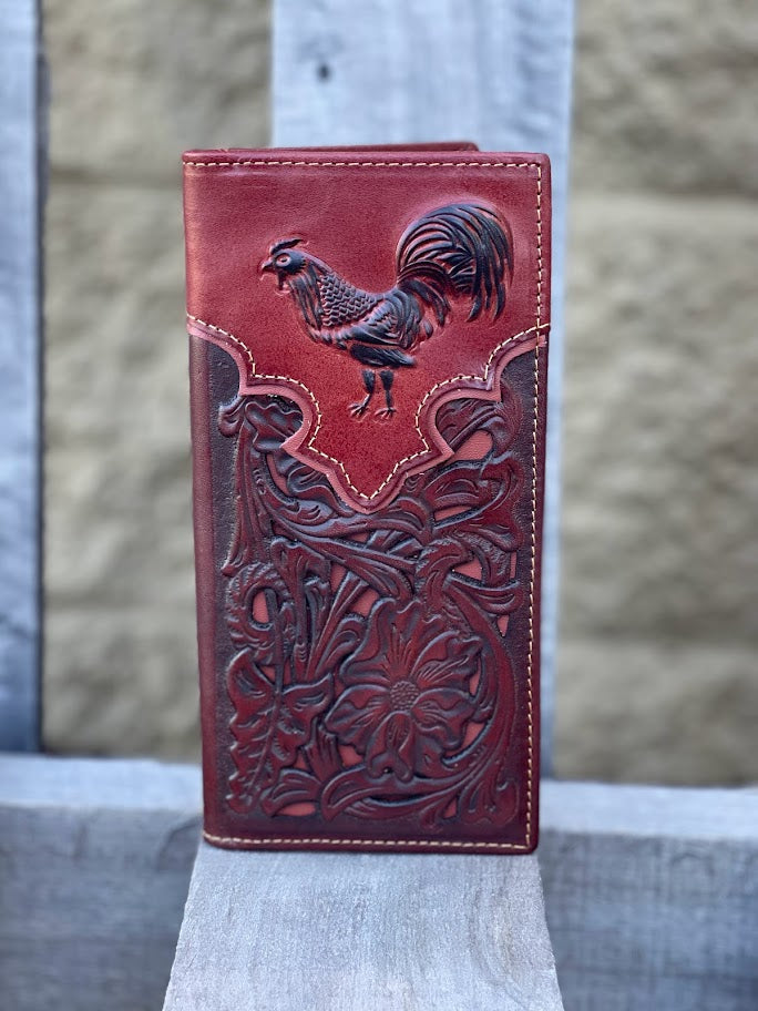 Brown leather wallet with rooster design on a wooden surface