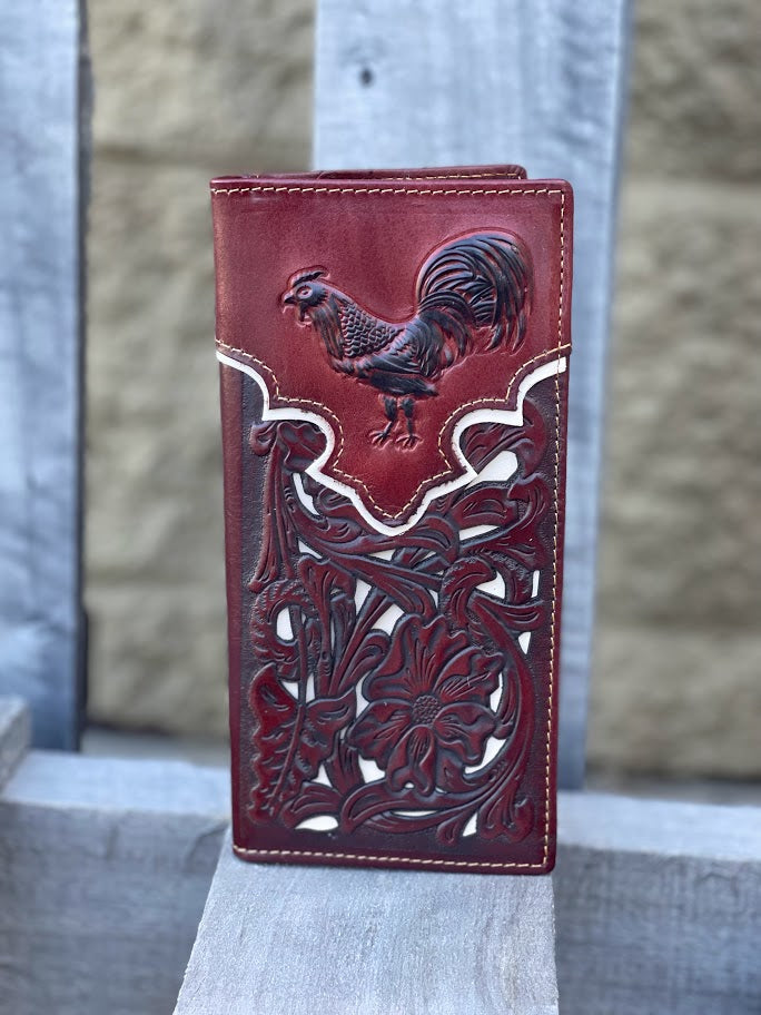 Brown leather wallet with rooster design on a stone surface