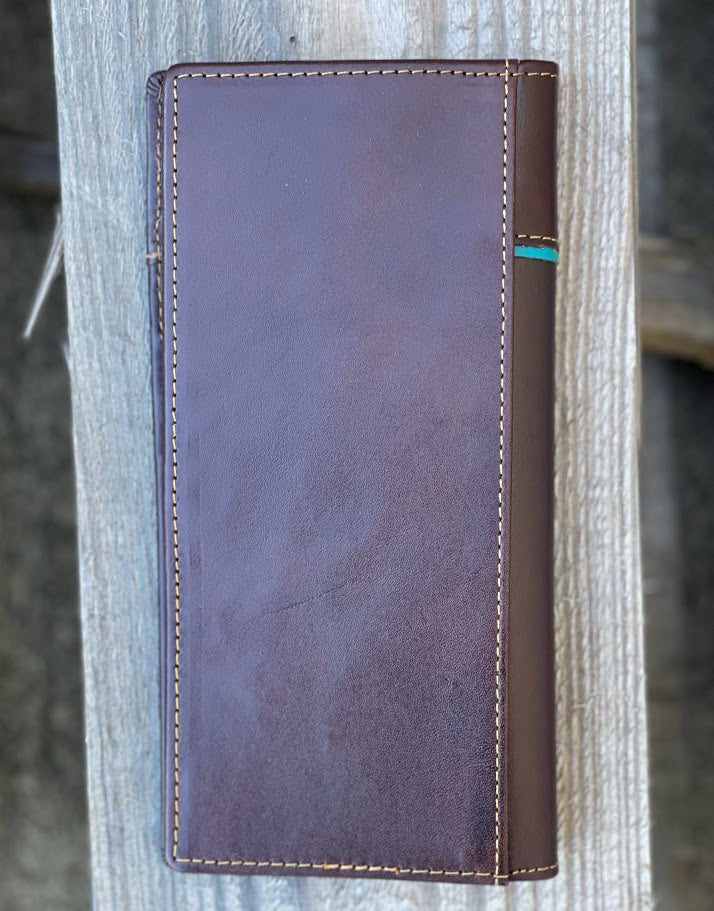 Coffee Brown leather wallet with brown accents on a wooden surface