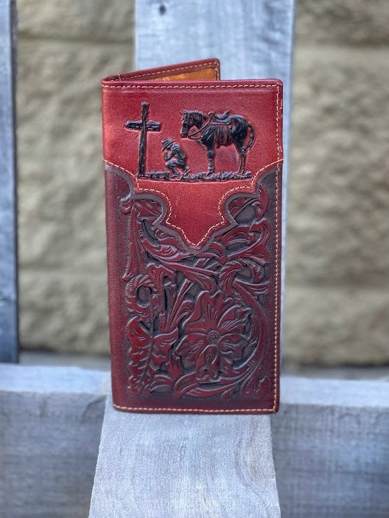 Brown leather wallet with intricate designs on a stone surface