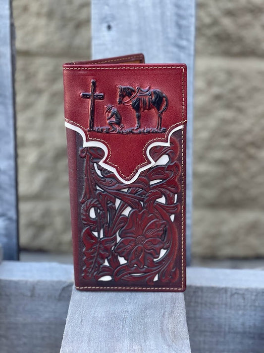 Brown leather wallet with intricate designs on a wooden surface