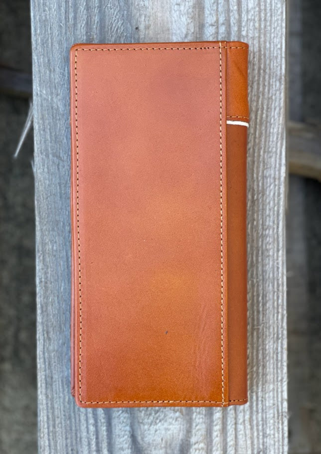 Light Brown leather wallet attached to a wooden post