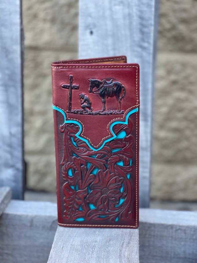 Brown leather wallet with intricate designs and blue accents on a stone surface.