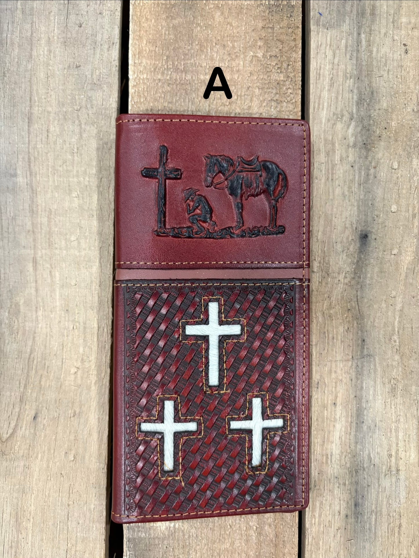 Brown leather cover with embossed designs of crosses and a horse, featuring metal cross symbols.