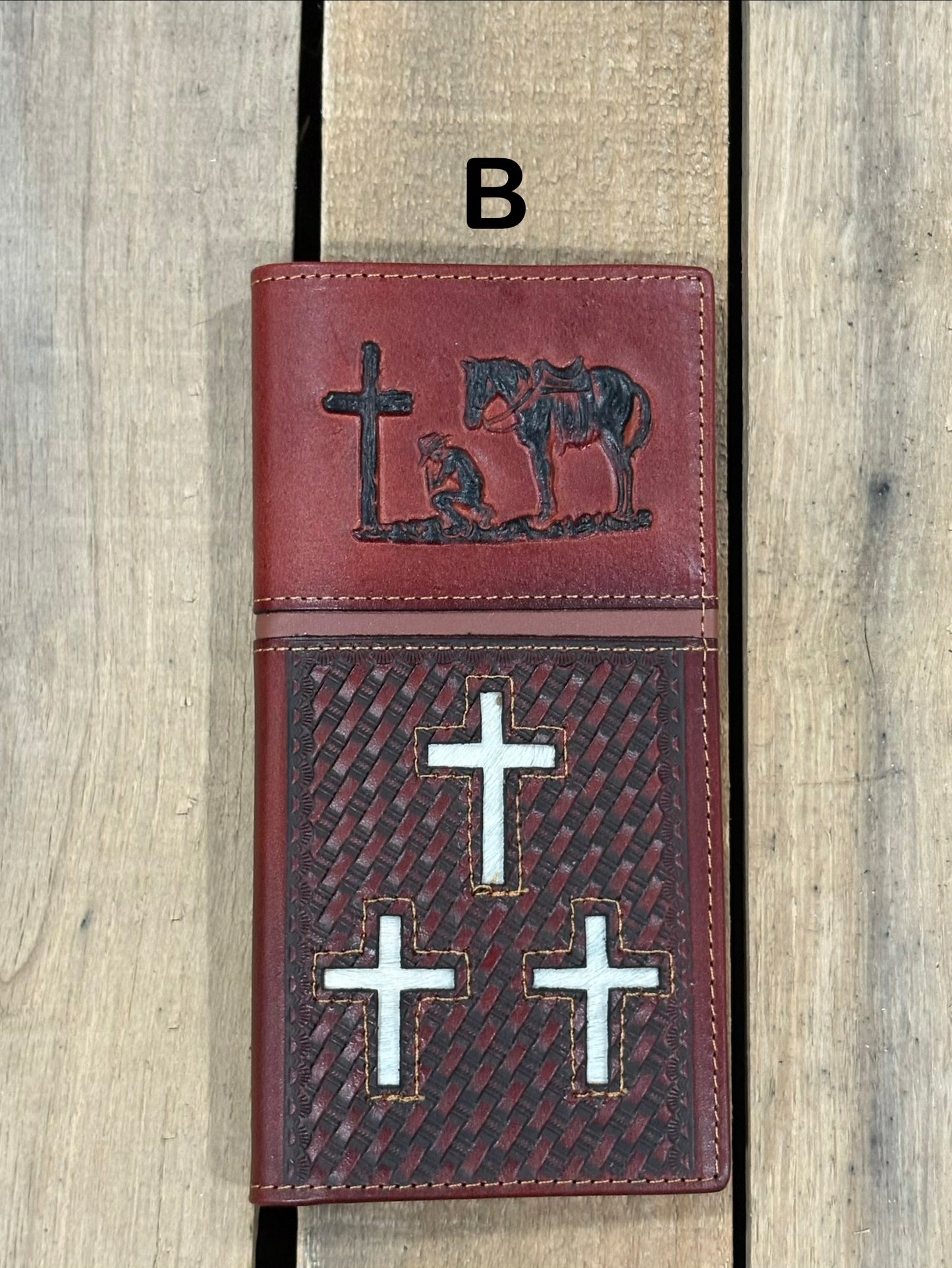 Brown leather cover with embossed designs of crosses and a horse, featuring metal cross symbols.