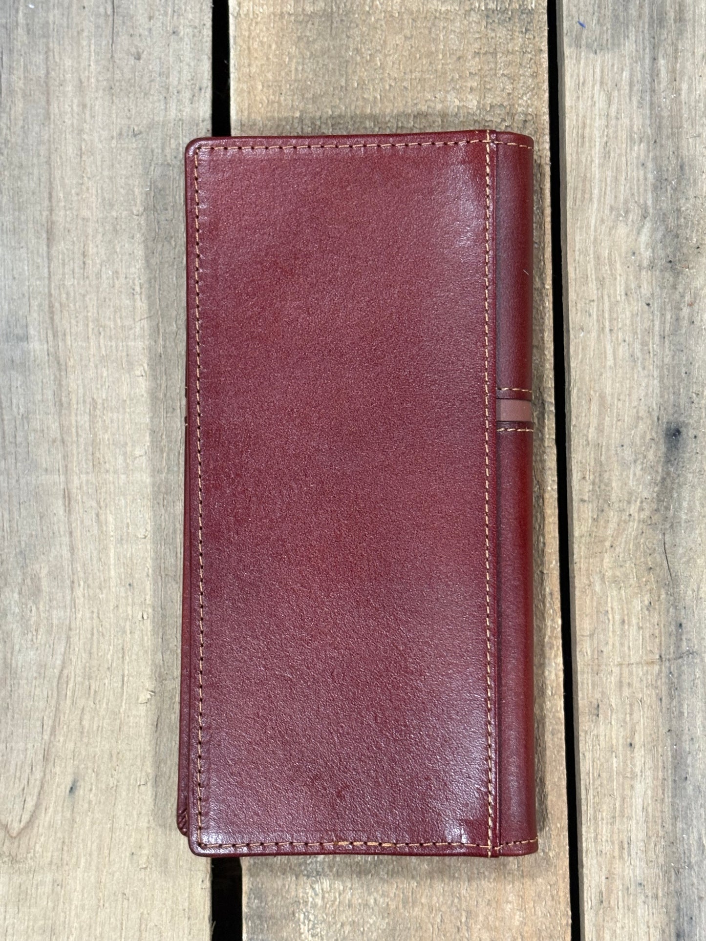 Brown leather wallet on a wooden surface