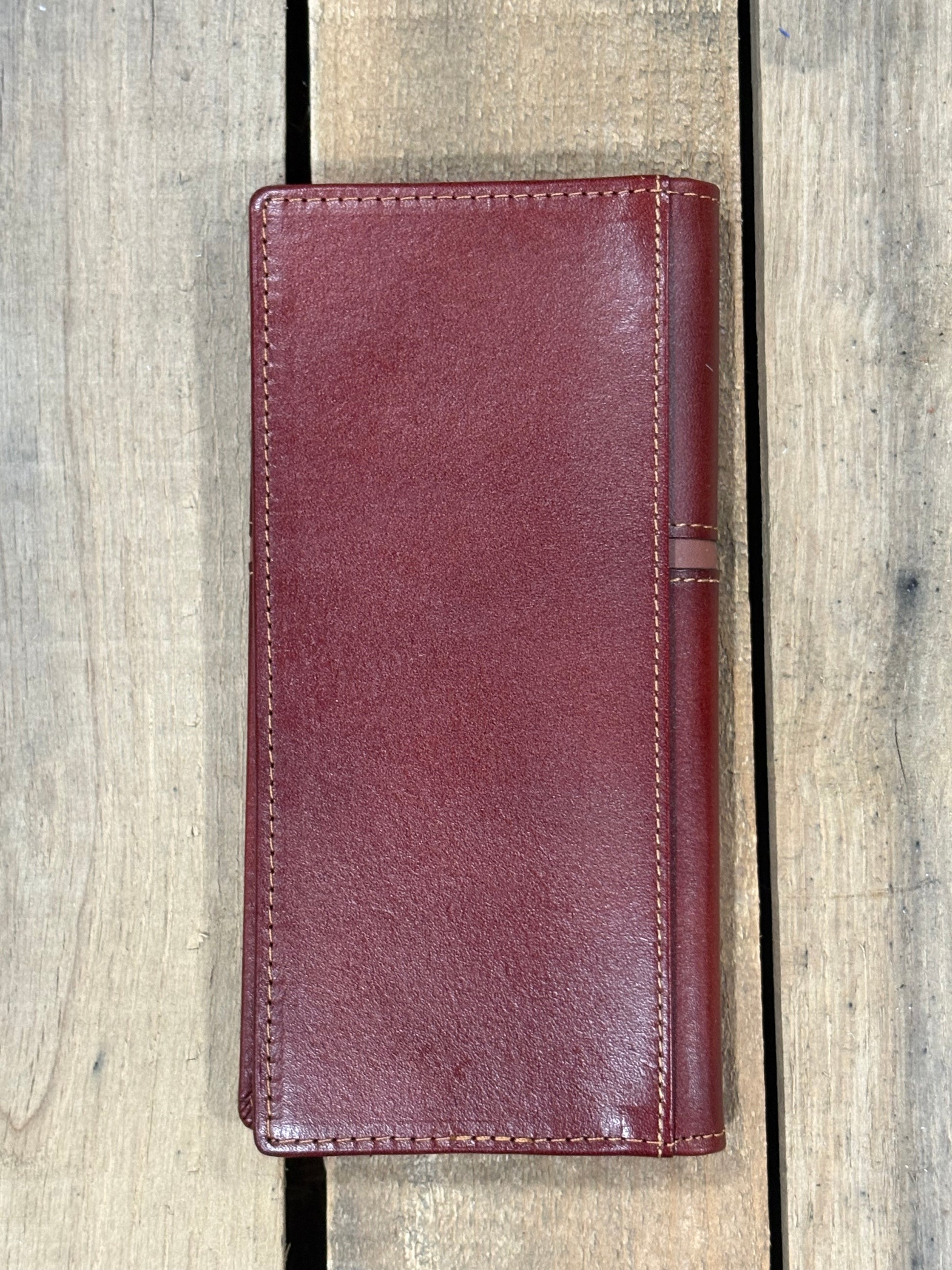 Brown leather wallet on a wooden surface