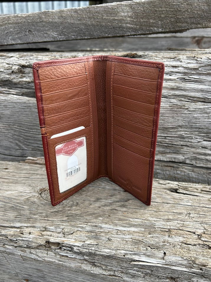 Brown leather wallet with a visible brand label on a wooden surface