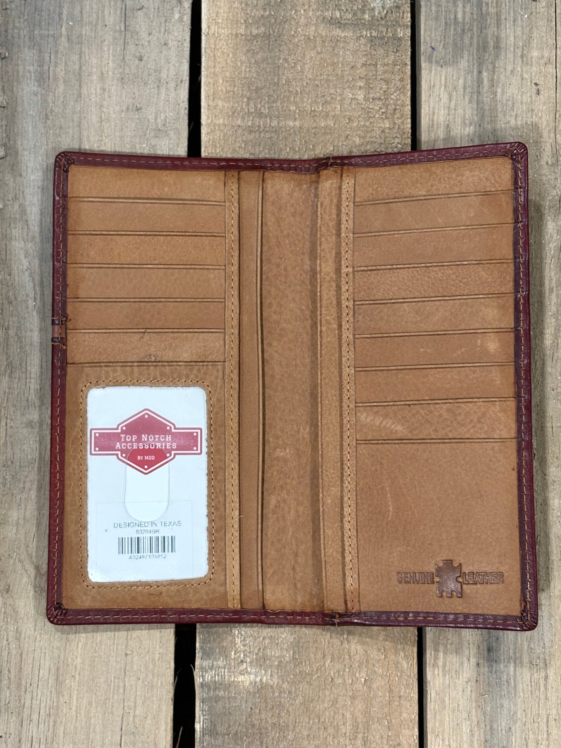 Brown leather wallet with a visible brand label on a wooden surface