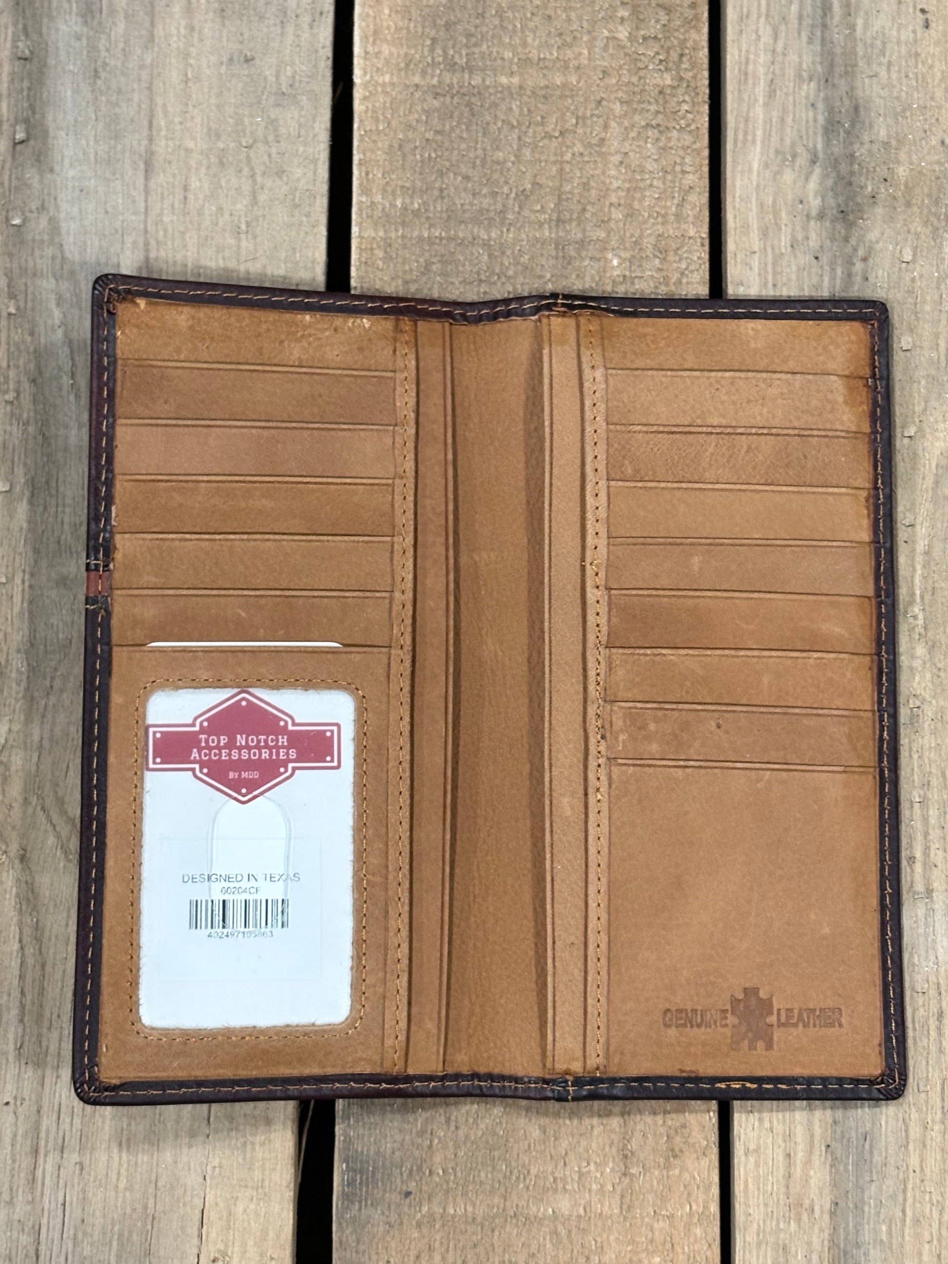 Brown leather wallet with a brand label on a wooden surface