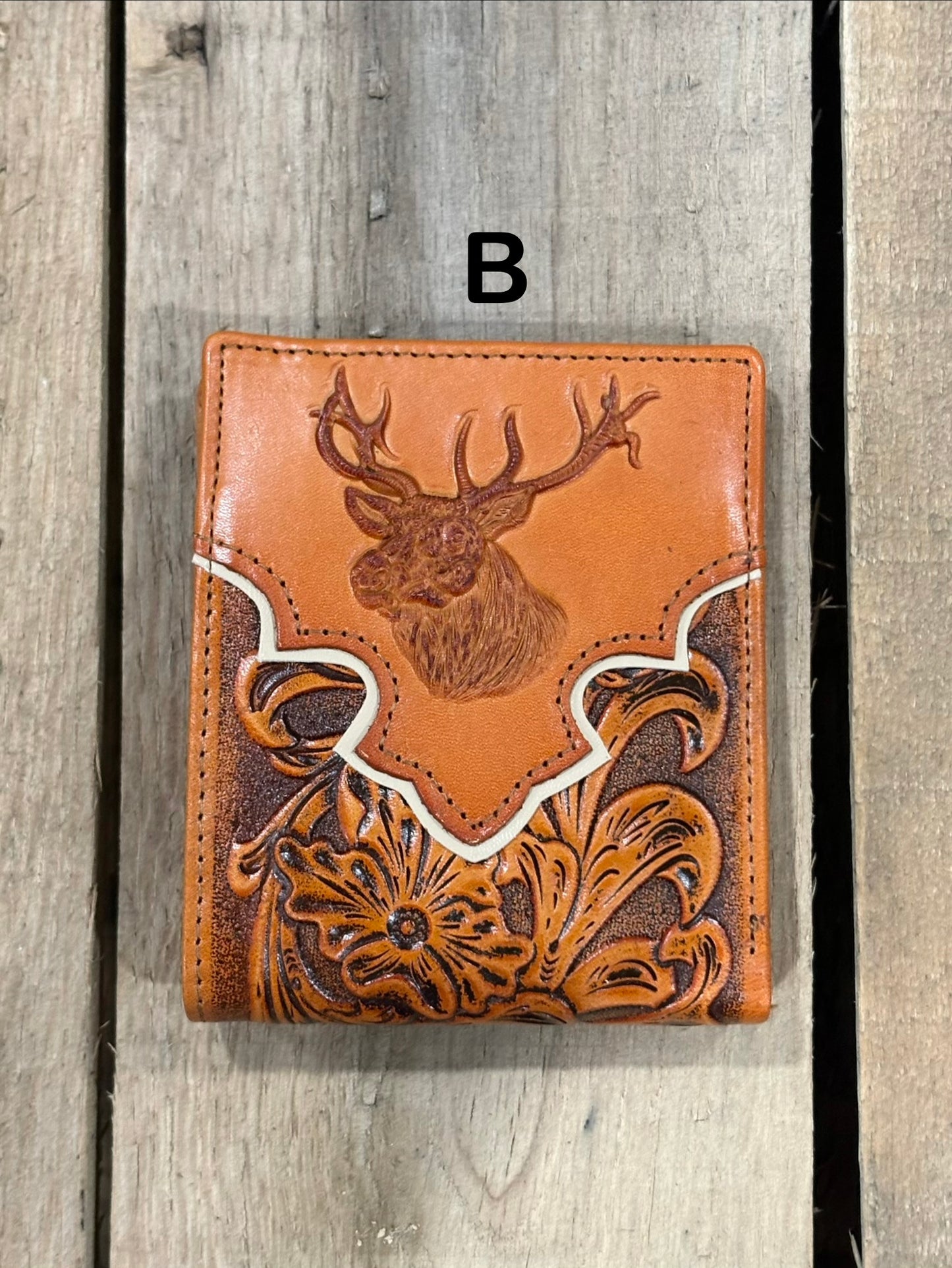 Light Brown leather wallet with deer head design on a wooden surface