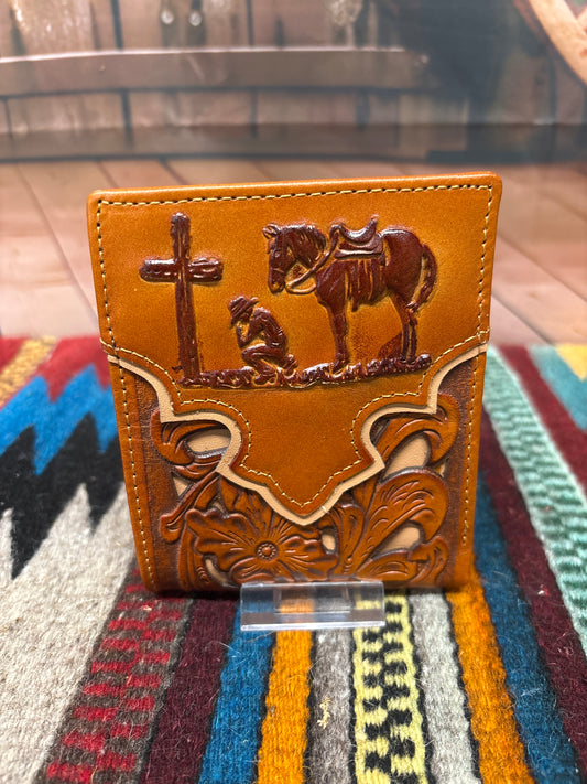 This Brown leather bifold wallet features a embossed Praying Cowboy design and a beige inlay under a tooled pattern. Front View