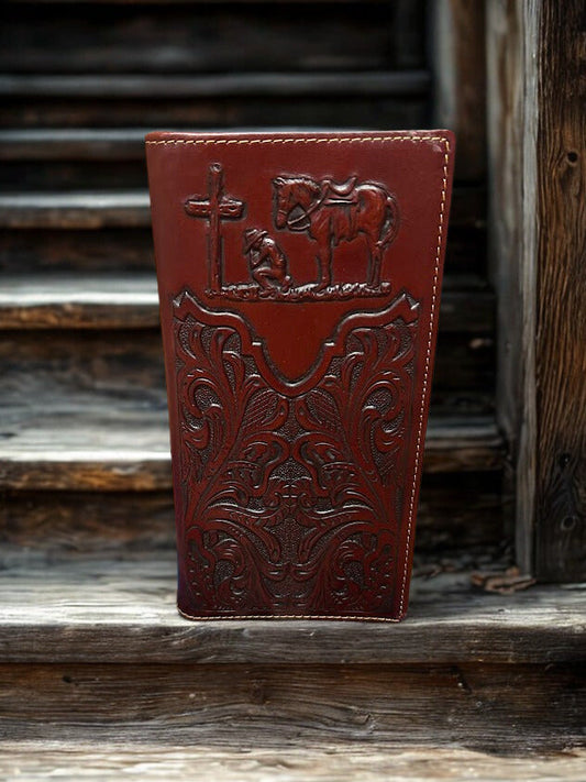 Brown leather wallet with embossed designs on a wooden surface