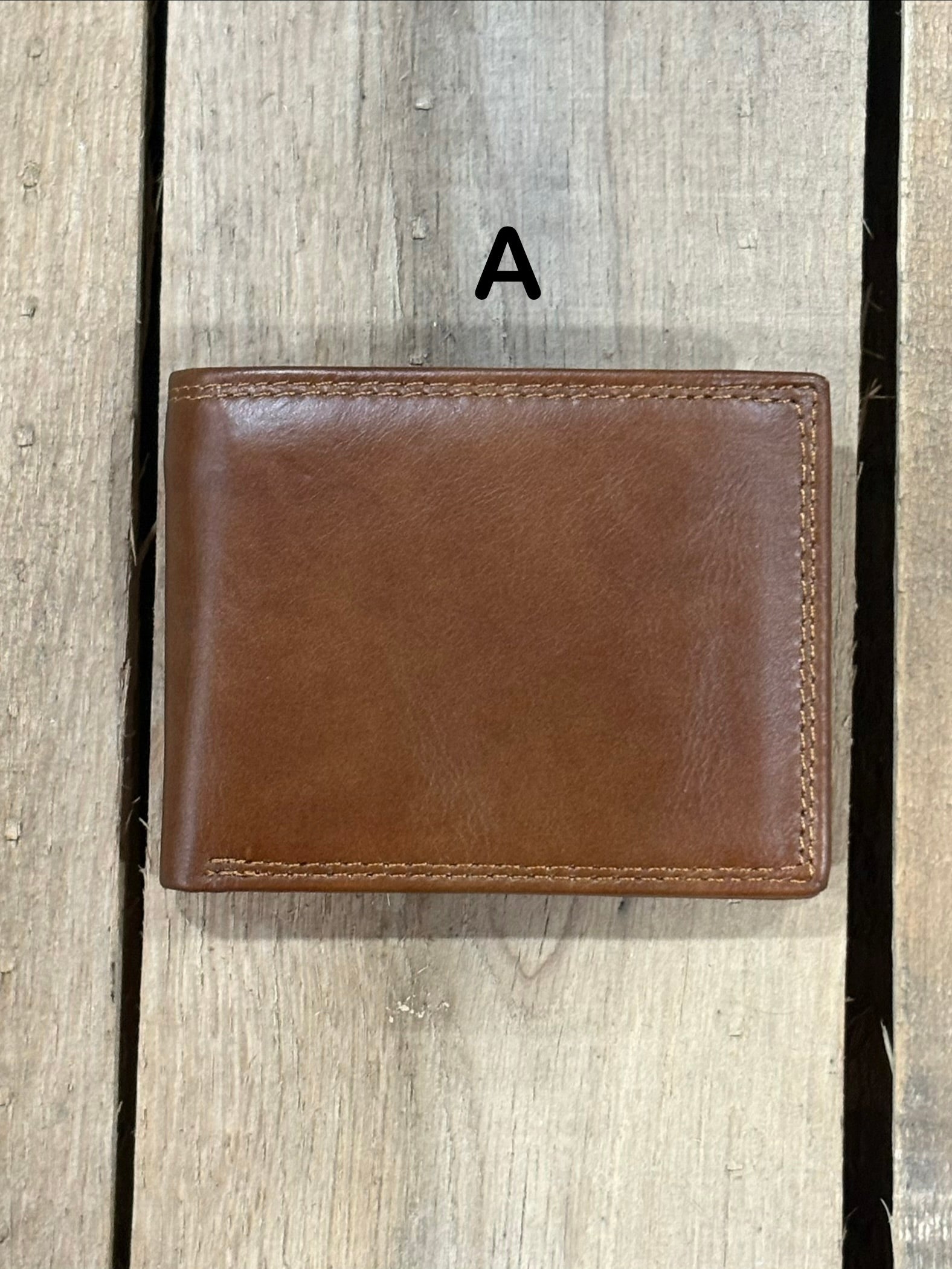 Brown smoothe leather wallet on a wooden surface