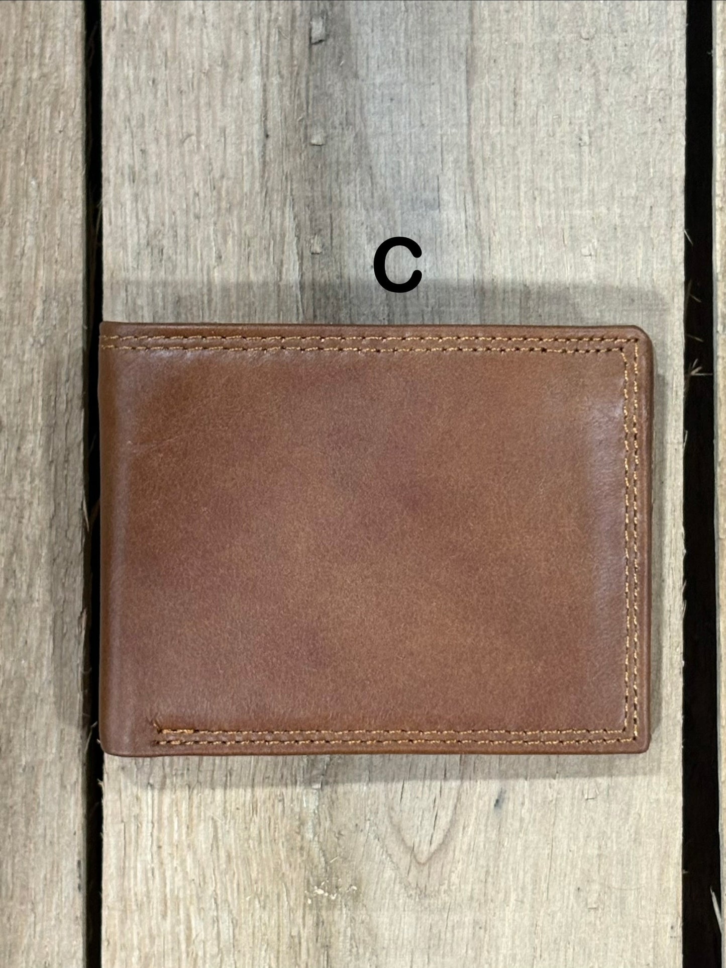Brown smoothe leather wallet on a wooden surface