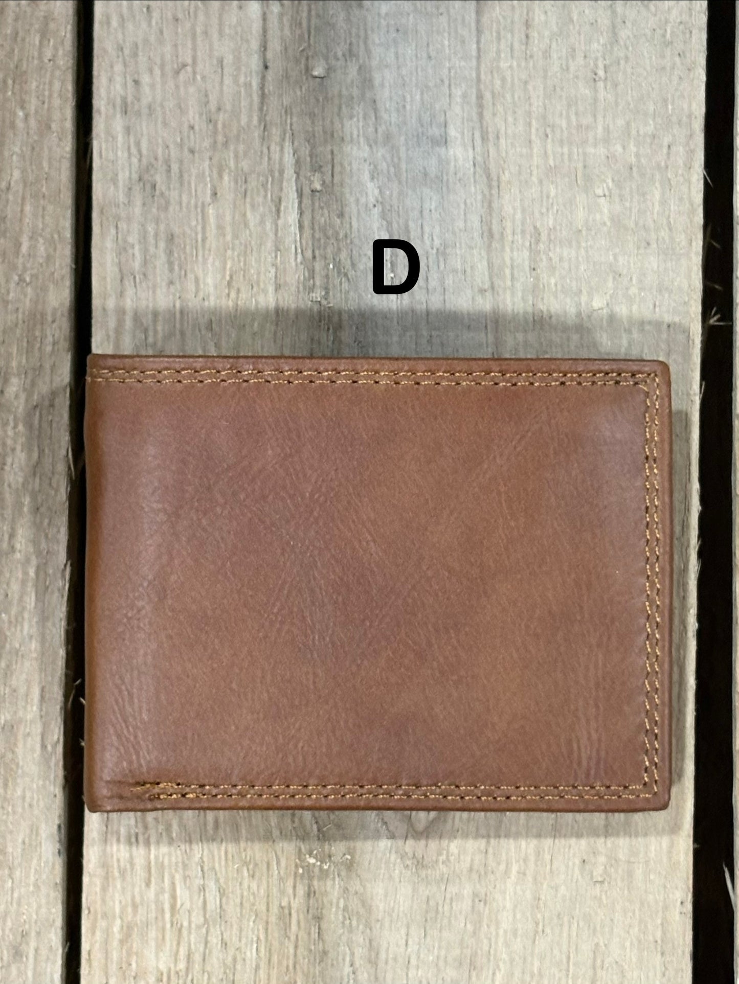 Brown smoothe leather wallet on a wooden surface