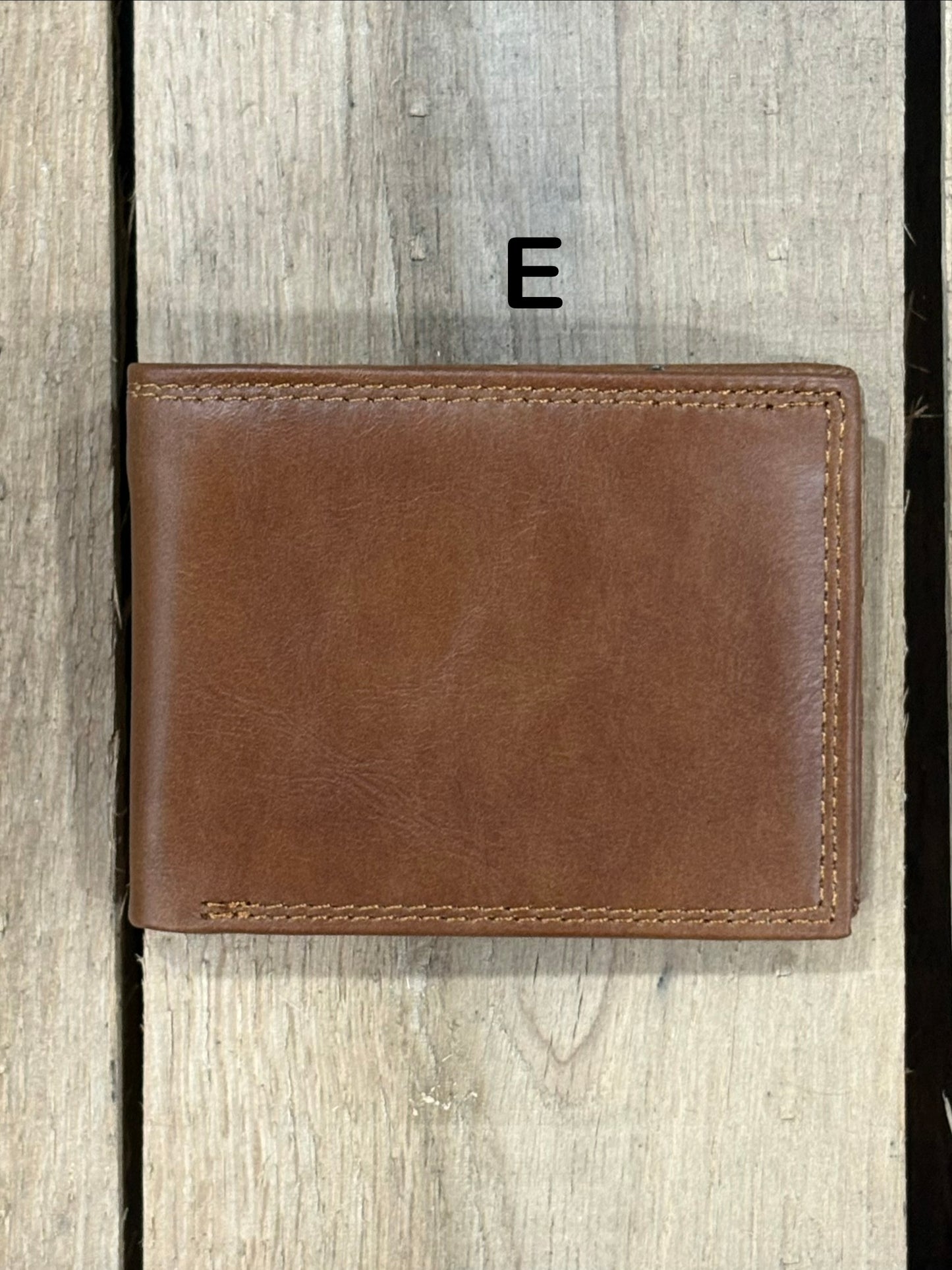 Brown smoothe leather wallet on a wooden surface