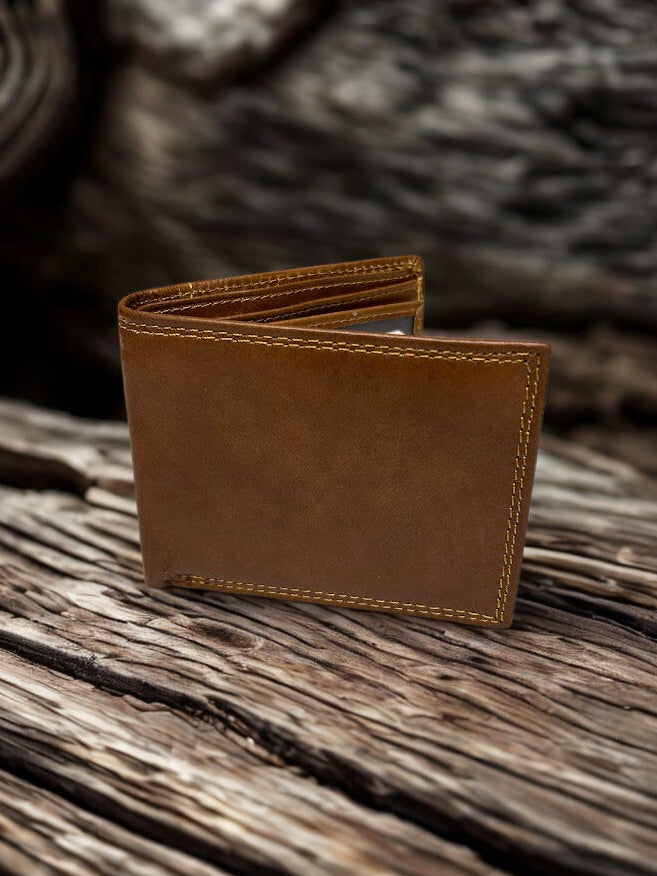 Brown leather wallet on a wooden surface with a blurred natural background