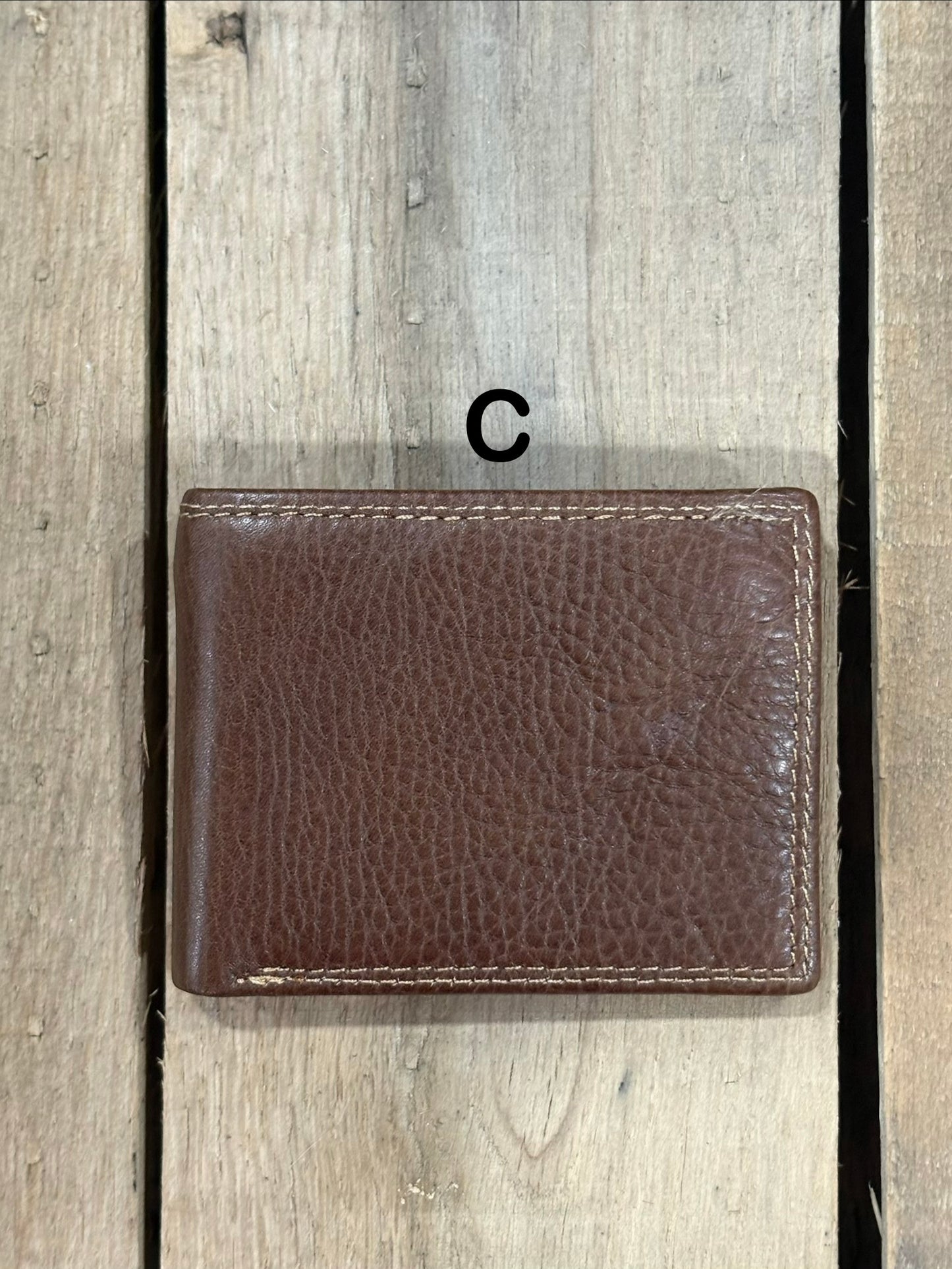 Coffee Brown smooth leather wallet on a wooden surface
